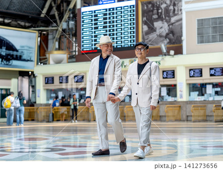 Couple senior lover of lgbt walk together in front of ticket counter of train station with happiness. 141273656