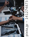 Professional Doctor Offers Comforting Support Holding a Patients Hand During Medical Consultation 141274873