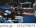 Professional Doctor Offers Comforting Support Holding a Patients Hand During Medical Consultation 141274874