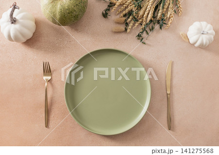 Autumn Thanksgiving table setting with pumpkins and green plate Autumn Thanksgiving table setting with pumpkins and green plate 141275568