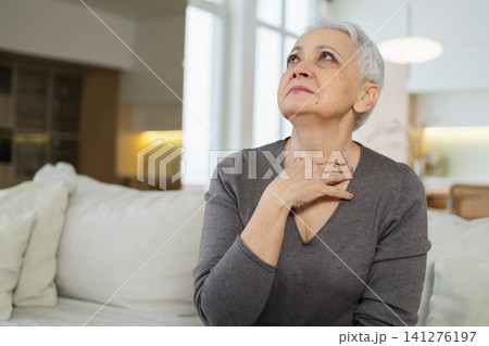 Sad tired ill sick lonely disappointed older senior woman sitting at home alone. Unhappy mature grandmother experiencing grief relative death bad news. Stressed elder lady suffering from loneliness Sad tired ill sick lonely disappointed older senior woman sitting at home alone. Unhappy mature grandmother experiencing grief relative death bad news. Stressed elder lady suffering from loneliness 141276197