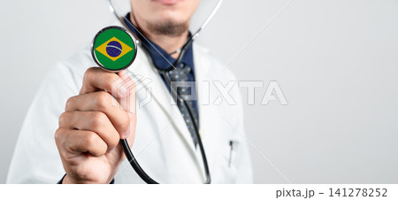 Brazil healthcare system, Brazilian national healthcare concept. Hand of doctor holding stethoscope Brazil healthcare system, Brazilian national healthcare concept. Hand of doctor holding stethoscope 141278252