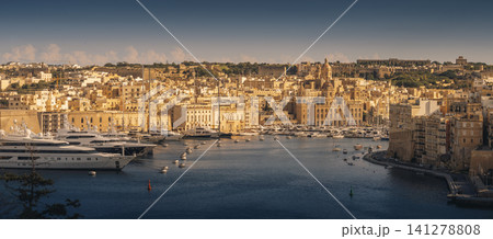 VALLETTA, MALTA - NOVEMBER 12, 2018 - The Grand Harbor Tricity bay, Birgu and Senglea islands with ships and boats in the port VALLETTA, MALTA - NOVEMBER 12, 2018 - The Grand Harbor Tricity bay, Birgu and Senglea islands with ships and boats in the port 141278808