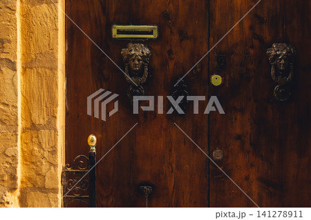 Old vintage weathered wooden door of Malta Old vintage weathered wooden door of Malta 141278911