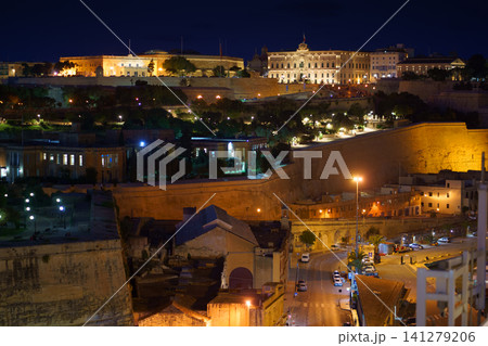 VALLETTA, MALTA - NOVEMBER 12, 2018 - Panoramic night view of a coast line and the downtown of the city with different landmarks 141279206