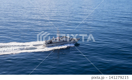 MESSINA, ITALY - 06 NOVEMBER, 2018: Speedboat Guardia di Finanza in the open sea with waves behind it MESSINA, ITALY - 06 NOVEMBER, 2018: Speedboat Guardia di Finanza in the open sea with waves behind it 141279215