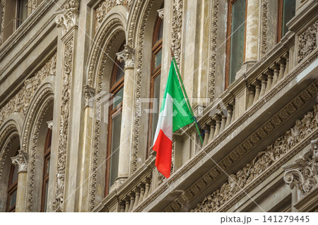 Naples, Italy - Nov 5 2018, Panoramic view of the Neo-Renaissance facade with the Italian flag flattering on the flagpole, in the Galleria Umberto I, without people, Naples, Italy Naples, Italy - Nov 5 2018, Panoramic view of the Neo-Renaissance facade with the Italian flag flattering on the flagpole, in the Galleria Umberto I, without people, Naples, Italy 141279445