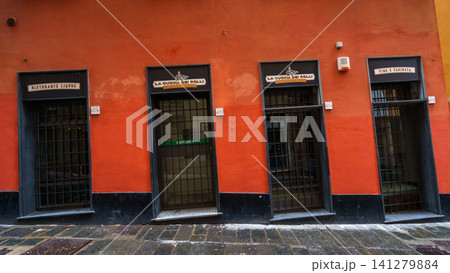 GENOA, ITALY - NOVEMBER 04, 2018 - Narrow streets of the old city with the doors GENOA, ITALY - NOVEMBER 04, 2018 - Narrow streets of the old city with the doors 141279884
