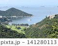 Scenic coastal landscape with golf course and sailboats in a bay Scenic coastal landscape with golf course and sailboats in a bay 141280113