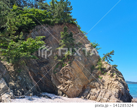 It is a beach with cliffs. It is a beach with cliffs. 141285324