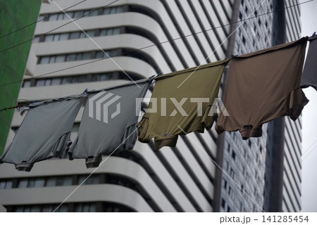 Urban contrast in Batumi with laundry drying against modern skyscraper backdrop Urban contrast in Batumi with laundry drying against modern skyscraper backdrop 141285454