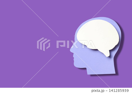 Purple backdrop shows paper cutout of head and brain Purple backdrop shows paper cutout of head and brain 141285939