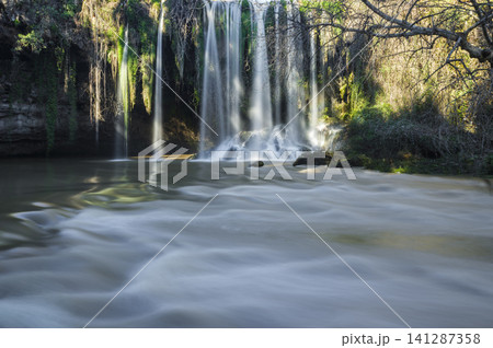 Powerful waterfall surrounded by nature 141287358
