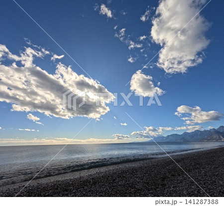 Scenic sunset with calm sea and dramatic clouds Scenic sunset with calm sea and dramatic clouds 141287388