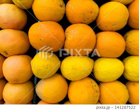 Healthy oranges and lemons at a grocery market stall Healthy oranges and lemons at a grocery market stall 141287522