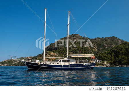 Traditional wooden gulet boat anchored in sea bay Turkey Traditional wooden gulet boat anchored in sea bay Turkey 141287631
