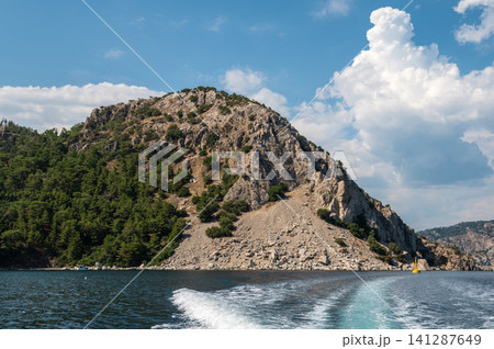 Beautiful sea wave trace from boat with mountain coast Beautiful sea wave trace from boat with mountain coast 141287649