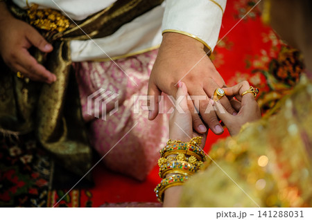 wedding rings together in hands 141288031