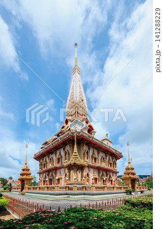 Thai style buddhis temple in cloudy bright blue sky Thai style buddhis temple in cloudy bright blue sky 141288229