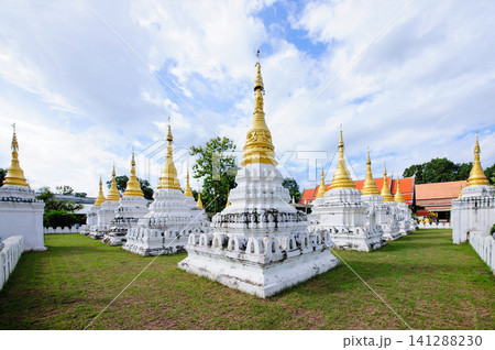 Thai style buddhis temple in cloudy bright blue sky Thai style buddhis temple in cloudy bright blue sky 141288230
