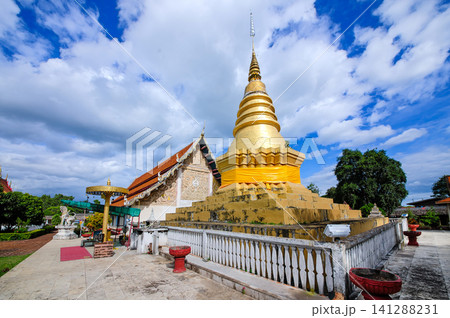 Thai style buddhis temple in cloudy bright blue sky Thai style buddhis temple in cloudy bright blue sky 141288231