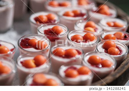 Many cup of yogurt panna cotta with watermelon topping, shot with narrow focus. Many cup of yogurt panna cotta with watermelon topping, shot with narrow focus. 141288241