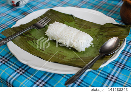 steamed rice with banana leaf spoon and folk on a dish steamed rice with banana leaf spoon and folk on a dish 141288248