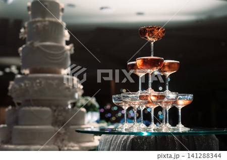 small tower of champagne's glass in wedding reception party small tower of champagne's glass in wedding reception party 141288344