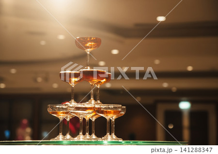 small tower of champagne's glass in wedding reception party small tower of champagne's glass in wedding reception party 141288347