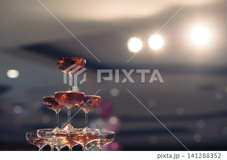 small tower of champagne's glass in wedding reception party 141288352