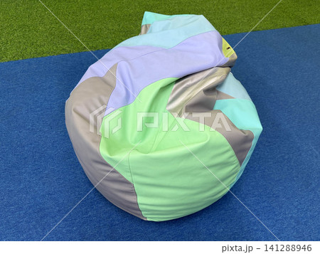 Colorful pastel soft bean bag chair on blue floor in kids playroom interior with copy space Colorful pastel soft bean bag chair on blue floor in kids playroom interior with copy space 141288946
