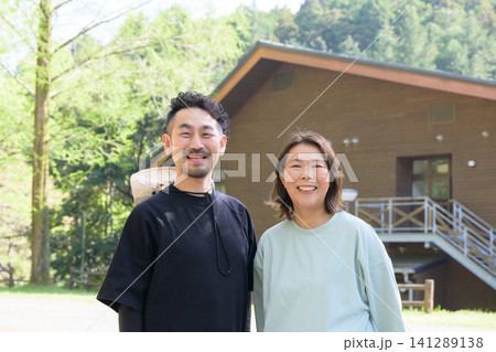 ペンション前に立つ笑顔の夫婦オーナー ペンション前に立つ笑顔の夫婦オーナー 141289138