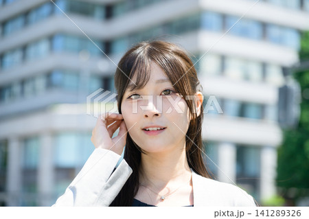 ビル街に立つ日本人女性 141289326