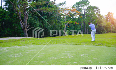 Golfers are putting golf in the evening golf course golf backglound. 141289786