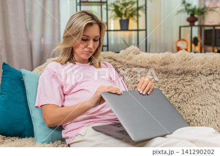 Pregnant woman closes laptop after client rejection in freelance work showing disappointed posture 141290202