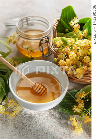 Linden honey in bowl with medicinal flowers Linden honey in bowl with medicinal flowers 141290306