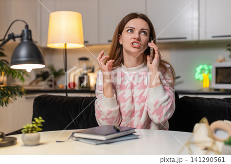 Adult woman shouts on smartphone at night rejects offer angry frown strong emotion stress upset mood 141290561