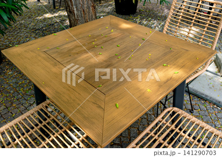 Top view close up of wooden tabletop with small yellow flowers and green buds Top view close up of wooden tabletop with small yellow flowers and green buds 141290703