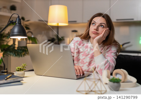 Adult woman irritated by workload waves hand on laptop ends late shift plans new start tomorrow Adult woman irritated by workload waves hand on laptop ends late shift plans new start tomorrow 141290799