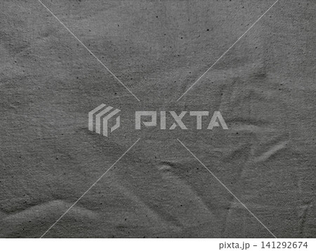 dark charcoal gray wrinkled cotton fabric texture background showing organic woven linen fibers dark charcoal gray wrinkled cotton fabric texture background showing organic woven linen fibers 141292674