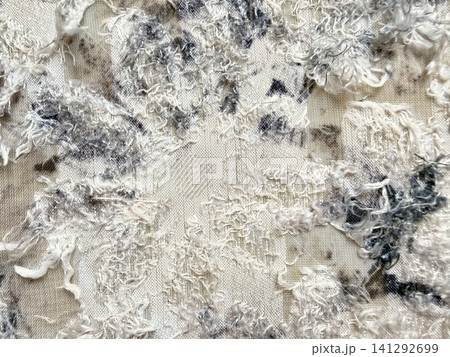 textured abstract fabric background with frayed white and grey threads creating an intricate organic pattern 141292699