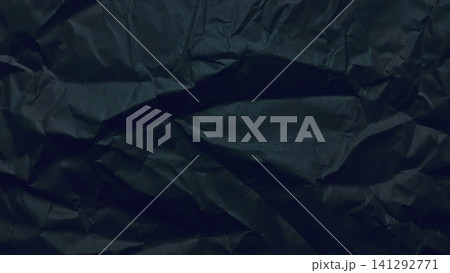 crumpled black paper texture creates dynamic shadows across a minimalist organic background with moody abstract folds 141292771