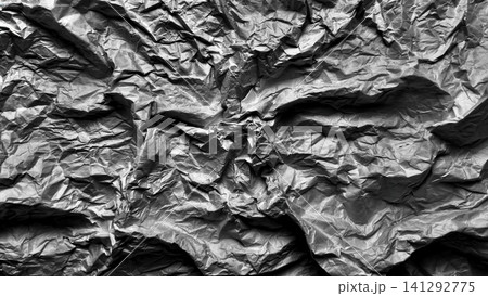 crumpled black paper texture displays detailed creases and harsh shadows in a dark monochrome minimalist background crumpled black paper texture displays detailed creases and harsh shadows in a dark monochrome minimalist background 141292775