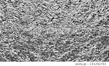 crumpled silver aluminum foil texture creates a metallic reflective surface with intricate crinkles and intense highlights crumpled silver aluminum foil texture creates a metallic reflective surface with intricate crinkles and intense highlights 141292781