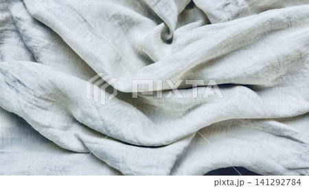 natural linen fabric texture background with elegant organic folds in soft overhead light creates a serene minimalist mood natural linen fabric texture background with elegant organic folds in soft overhead light creates a serene minimalist mood 141292784