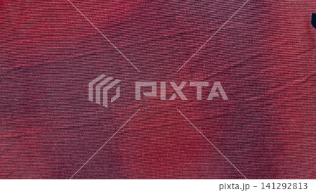 crimson corduroy fabric texture shows organic ribbed lines in a minimalist flat lay macro close up creating a cozy mood crimson corduroy fabric texture shows organic ribbed lines in a minimalist flat lay macro close up creating a cozy mood 141292813