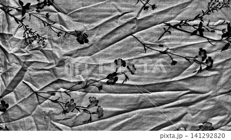 crumpled linen fabric texture features delicate black floral pattern in minimalist organic aesthetic background crumpled linen fabric texture features delicate black floral pattern in minimalist organic aesthetic background 141292820