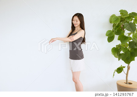 腕のストレッチをする若い女性 腕のストレッチをする若い女性 141293767
