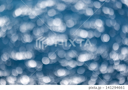 Blurred white lights are on blue background, natural photography Blurred white lights are on blue background, natural photography 141294661