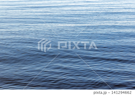 Shiny blue water surface with smooth ripple and reflections Shiny blue water surface with smooth ripple and reflections 141294662